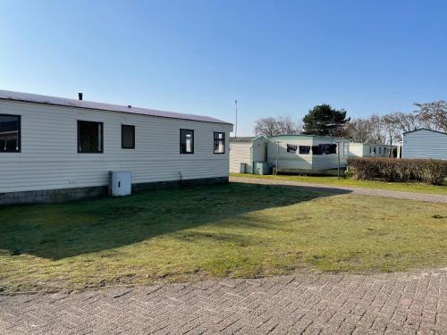 une grande cour à côté d'une maison et d'un bâtiment dans l'établissement zee van Buren, à Buren