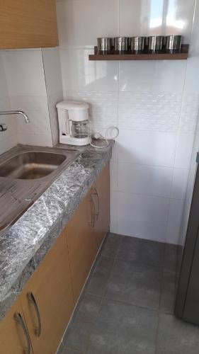 eine kleine Küche mit einer Spüle und einer Arbeitsplatte in der Unterkunft Tamesna HOUSE in Sidi Yahia az Zaʼer