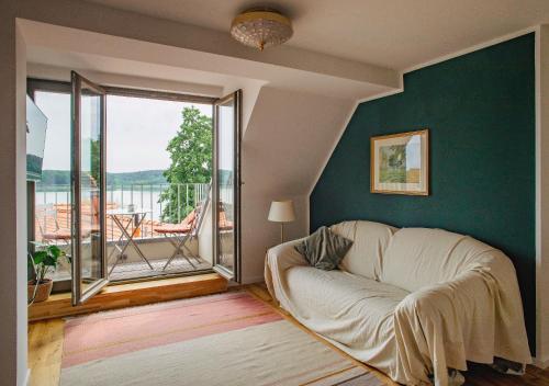 a living room with a couch and a large window at Sommerfrische Lychen in Lychen