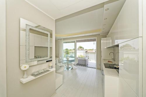 a white bathroom with a sink and a mirror at La Castellana C89 by Wonderful Italy in Sirmione