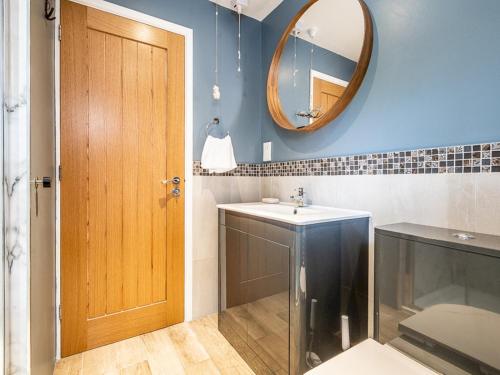 a bathroom with a sink and a mirror at Pass the Keys Stylish family home central Topsham with parking in Exeter