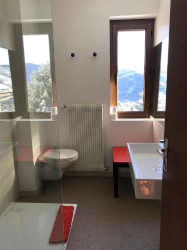a bathroom with a toilet and a window at La maison de Cécile in Ventron