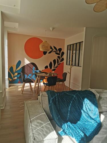 a living room with a couch and a table at Les clos de Givry - Clos Léonie - Appartement 68m2 spacieux, lumineux et avec sauna in Givry