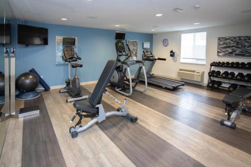 a gym with several treadmills and exercise machines at Candlewood Suites Miami Intl Airport - 36th St by IHG in Miami
