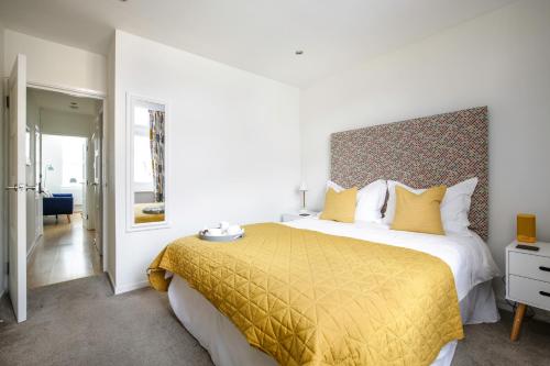 a bedroom with a large bed with a yellow bedspread at Perfect City Centre Location - Historic Albion Mews in Chester