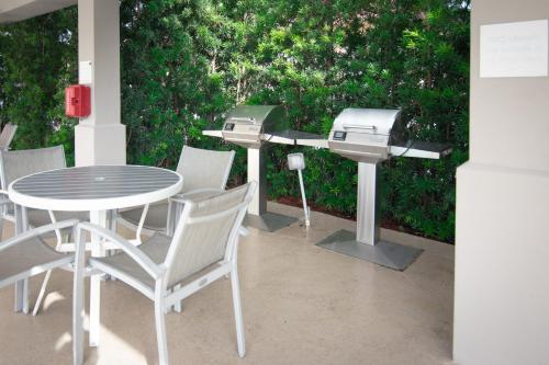a barbecue grill and table and chairs on a patio at Candlewood Suites Miami Intl Airport - 36th St by IHG in Miami