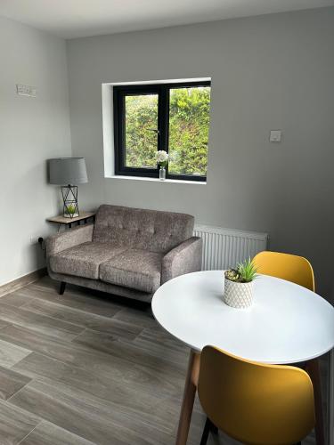 a living room with a couch and a table at Stylish Killorglin Apartment in Killorglin