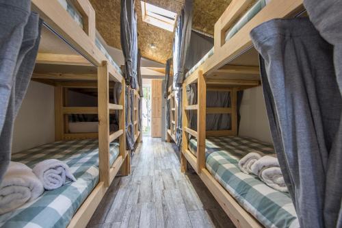 two bunk beds in a room with wooden floors at Vila Maria Mix Dorm by HOST-POINT in Costa da Caparica