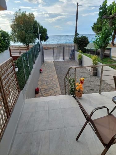 a patio with a view of the ocean at Akrotiri Luxury Suites in Trápeza
