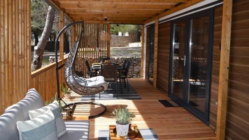 a screened porch with a hammock on a house at Lucas Mobile Home - premium mobile home with terrace and patio in Drage