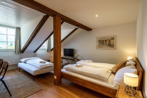 a bedroom with two beds in a attic at Heart of Interlaken Apartments in Interlaken