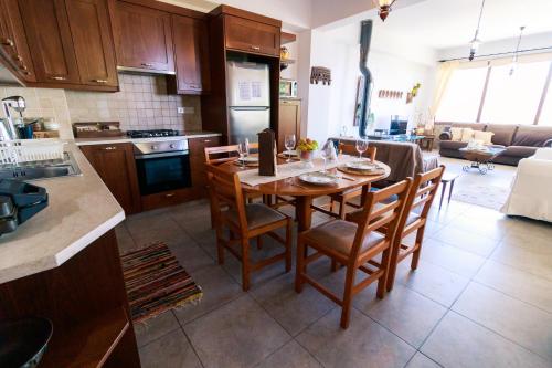 a kitchen and dining room with a table and chairs at Stella's Country House in Prodromos