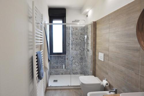 a bathroom with a shower and a toilet and a sink at Dalila's Apartment in Sirmione