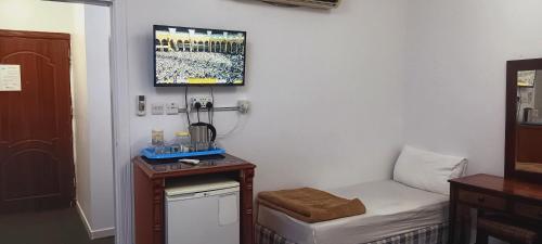 a small room with a bed and a small table at فندق الفخامة أوركيد 1 للغرف والشقق المفروشة in Makkah