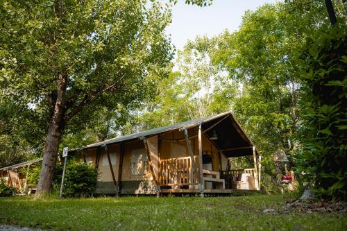 a tent in the middle of a field with trees at Glamping Tuscany in Capannole