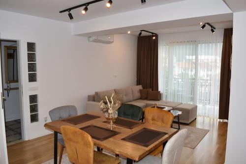 a dining room and living room with a table and chairs at Luxury Apartment Poli in Ohrid