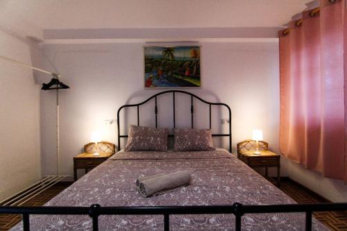 a bedroom with a large bed with a pillow on it at Nomad Villa Santa Fe in Las Palmas de Gran Canaria