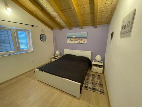 a bedroom with a bed and two night stands at Island Escape in Mali Iž