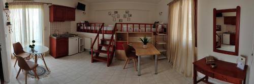 a room with a kitchen and a room with bunk beds at Filoxenia Apartments in Mytilene
