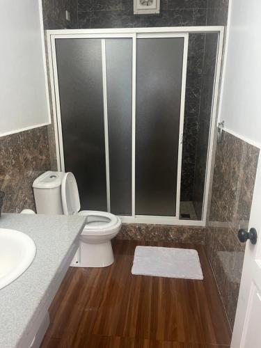 a bathroom with a toilet and a sink at MJay's Place in Paix Bouche
