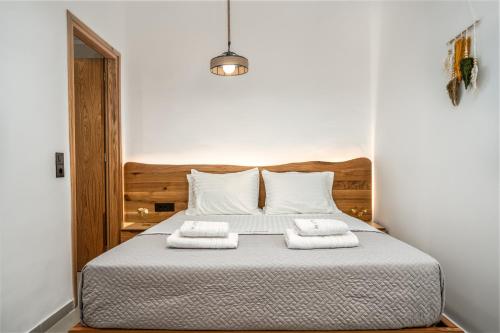 a bedroom with a bed with two towels on it at Amoudi Studios Apartments Hotel in Amoudi