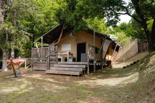 a house with a porch and stairs in front of it at Glamping Siena in Siena