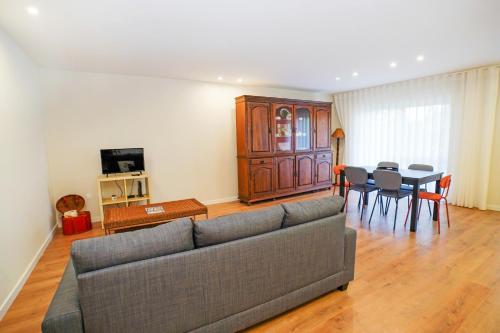 a living room with a couch and a table at Casa da Avó Toninha by Quantique in Braga