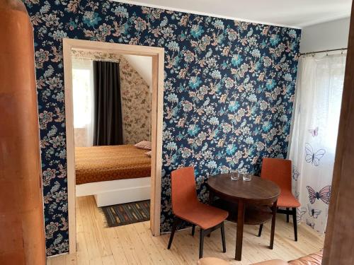 a room with a table and a mirror and a bedroom at Small Villa Subbi! in Tartu