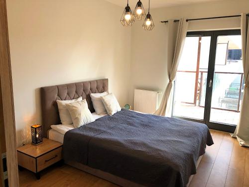 a bedroom with a bed and a large window at Apartimento Angel River 7 in Wrocław