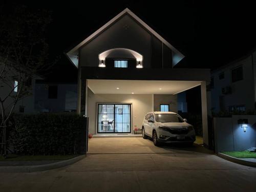a car parked in front of a house at night at MOST Family 456/66 Ubon-Thailand in Ubon Ratchathani