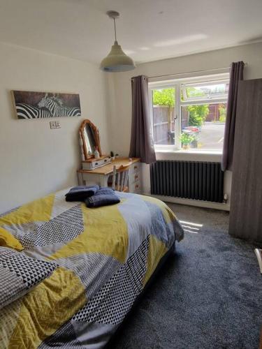 a bedroom with a bed and a window at Squirrel's Retreat in Thornton