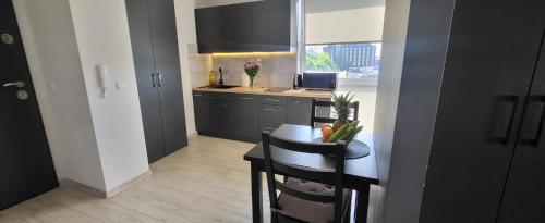 a small kitchen with a table and a counter top at Centrum Prusa Prestige 211 in Lublin