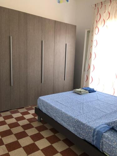 a bedroom with a bed and wooden cabinets at Montefusco in Crotone