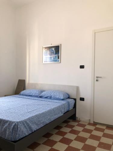 a bedroom with a bed and a picture on the wall at Montefusco in Crotone