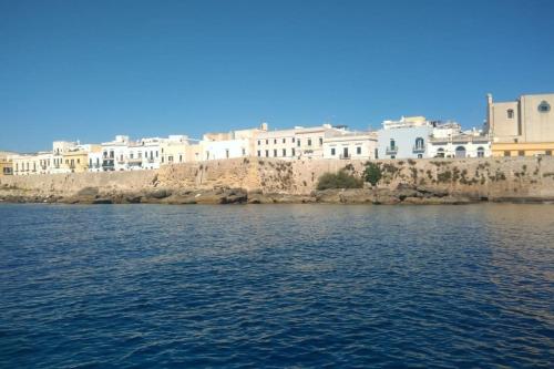 a view of a body of water with buildings in the background at Dimora Collina 2 in Sannicola