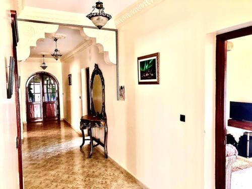 a hallway with a mirror and a table in a room at Villa tranquility in Tangier