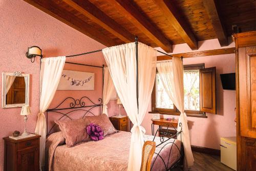 a bedroom with a canopy bed and a window at Garden Cactus in Villaggio Mosè
