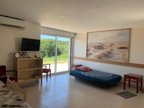 a living room with a couch and a flat screen tv at Kerrouz in Bannalec