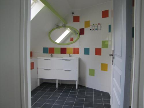 a bathroom with a sink and a mirror on the wall at Kerrouz in Bannalec