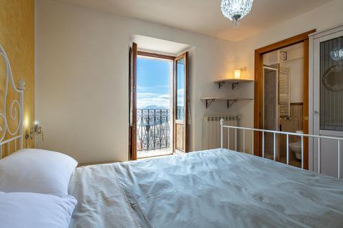 a bedroom with a large bed and a large window at Cuore Nero Food and Relax in Santo Stefano di Sessanio