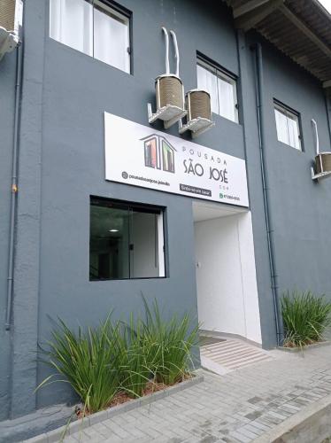 a building with a sign for a ski lodge at Pousada São José in Joinville