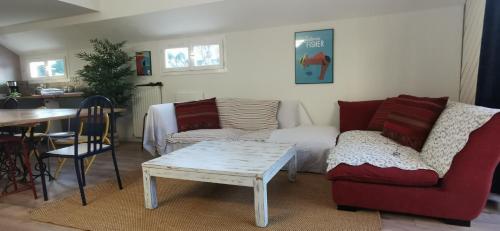 a living room with a couch and a table at Jolie péniche canal du Midi in Vias