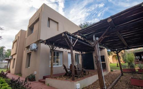 a house with a wooden pergola in front of it at Hacienda Don Justo Hotel Boutique Spa in Colón
