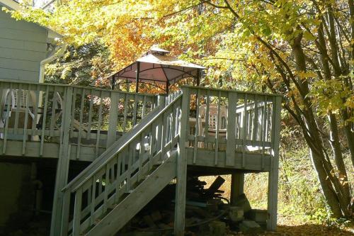 a wooden staircase with a gazebo next to a house at Catskill Mountain Retreat in West Kill