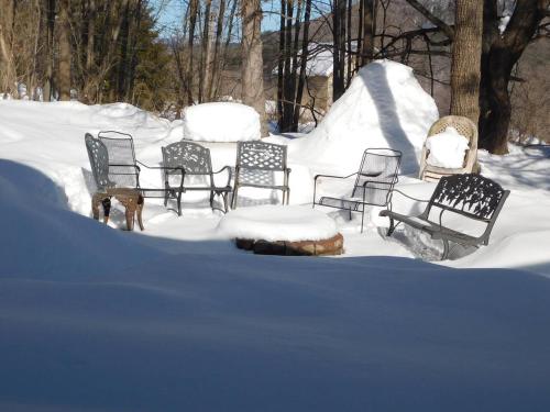 a group of chairs sitting in the snow at Catskill Mountain Retreat in West Kill