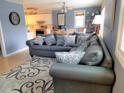 a living room with a gray couch with pillows at Catskill Mountain Retreat in West Kill