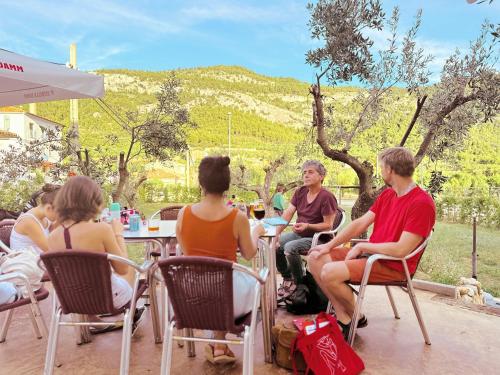 a group of people sitting at a table outside at Fonda Aparicio in Fuentespalda