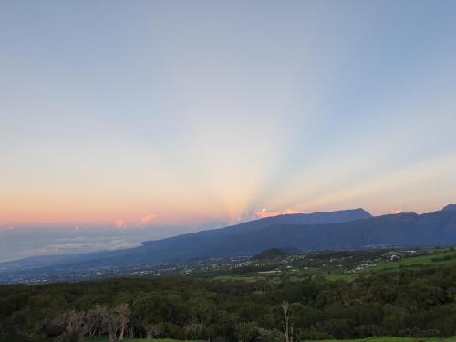 a rainbow in the sky over a mountain at Case Vi d' o' in Le Tampon