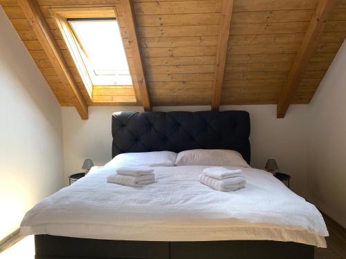 a bedroom with a large bed with towels on it at Podhradí Landštejn in Slavonice