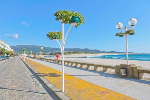 a street light on a sidewalk next to the beach at Beachfront Apartment in Vila Praia de Âncora